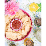 pink chip and dip server with salsa on a blue patterned tabelcloth