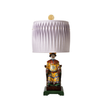 Decorative lamp with a figurine base on a white background