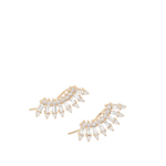 A pair of gold crescent-shaped stud earrings adorned with baguette-cut clear crystals, set against a plain white background.