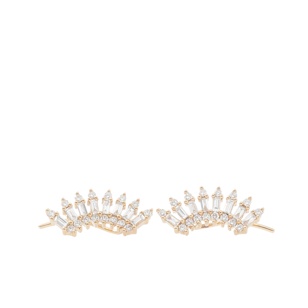 A pair of gold crescent-shaped stud earrings adorned with clear baguette and round-cut stones, displayed on a clean white background.