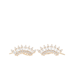 A pair of gold crescent-shaped stud earrings adorned with clear baguette and round-cut stones, displayed on a clean white background.