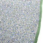 Floral patterned fabric with green border on a white background