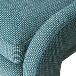 Close-up of textured teal fabric with a subtle pattern