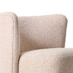 Close-up of a textured beige armchair on a white background