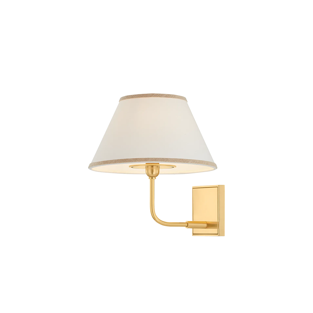 A modern wall sconce light fixture with a tapered off-white fabric shade and a polished gold metal arm and wall mount, shown against a plain white background.