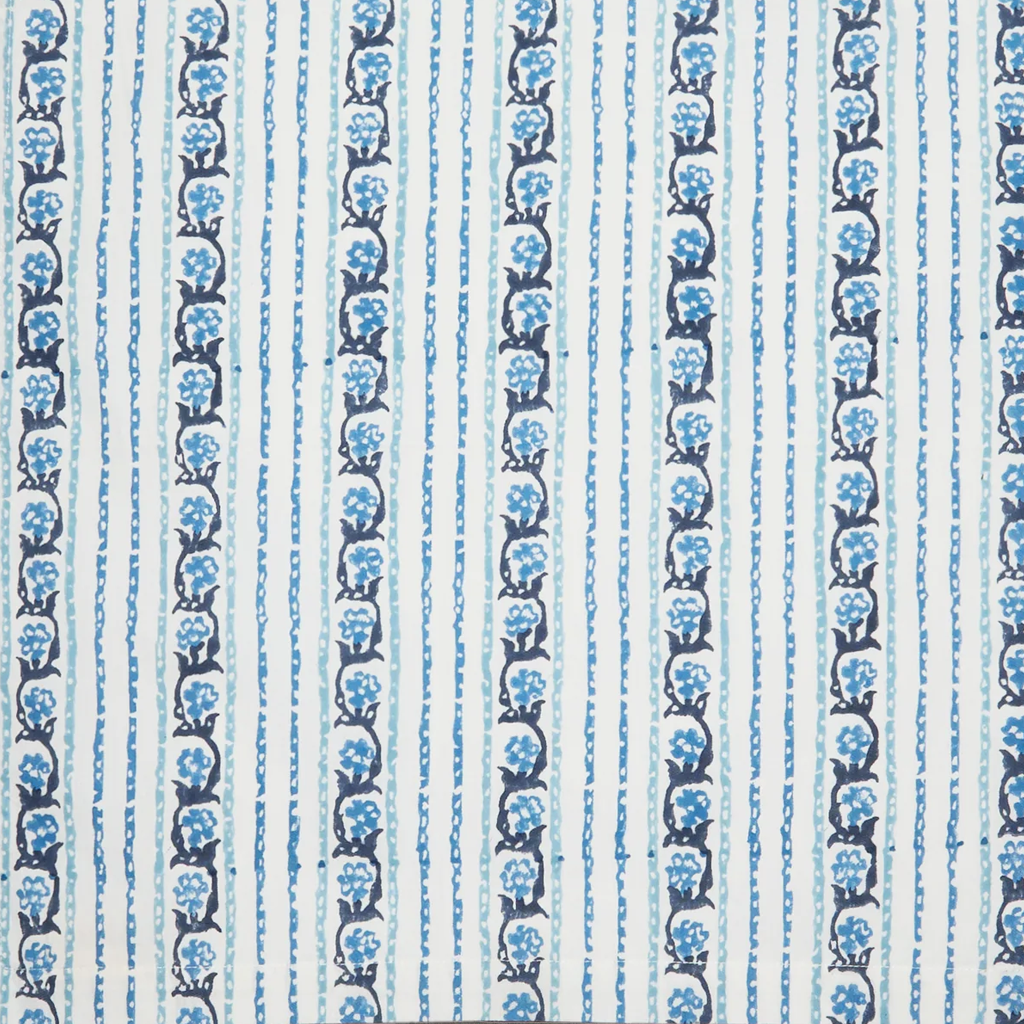 A close-up of a fabric pattern featuring vertical stripes in light blue, white, and dark navy blue, with repeating floral motifs.