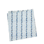 A folded square napkin featuring a vertical striped pattern in blue and navy on a white background.