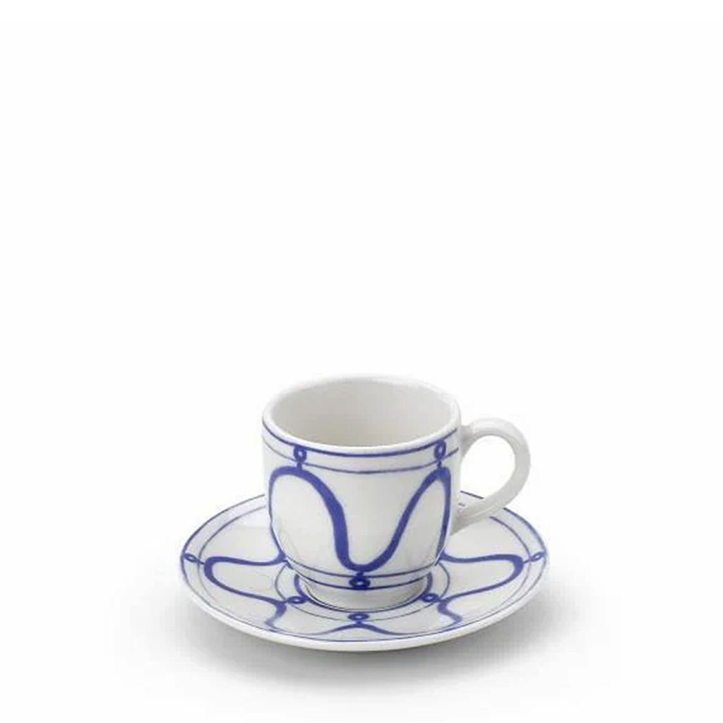 Ceramic cup and saucer with blue patterns on a white background