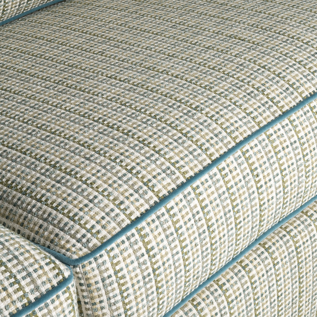 Close-up of textured fabric with a checkered pattern and blue border