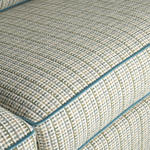 Close-up of textured fabric with a checkered pattern and blue border