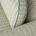Close-up of textured fabric with a checkered pattern and blue trim