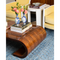 brown coffee table with books and vases on top 