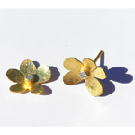 Gold flower-shaped earrings with diamond stud on a white background