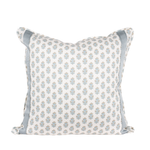 white pillow with blue flowers and trim