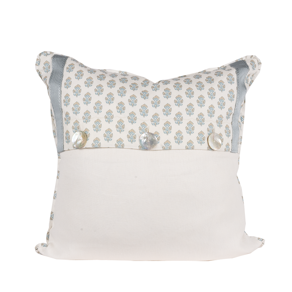 white pillow with blue flowers and trim