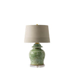 A table lamp with a green patterned ceramic jar base and a beige fabric drum shade, shown on a plain white background.