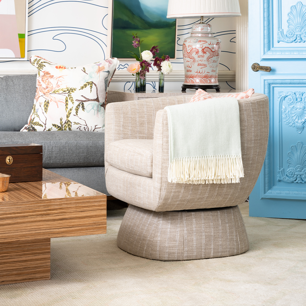 Modern living room with a beige armchair, wooden coffee table, and decorative elements.