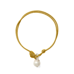 A gold braided cord bracelet with a knotted toggle closure and a dangling white pearl bead, shown on a plain white background.