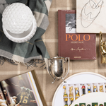 White golf ball textured ice bucket with lid on a plaid fabric background.