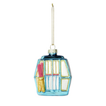 Decorative glass ornament shaped like a gondola with skis on a white background