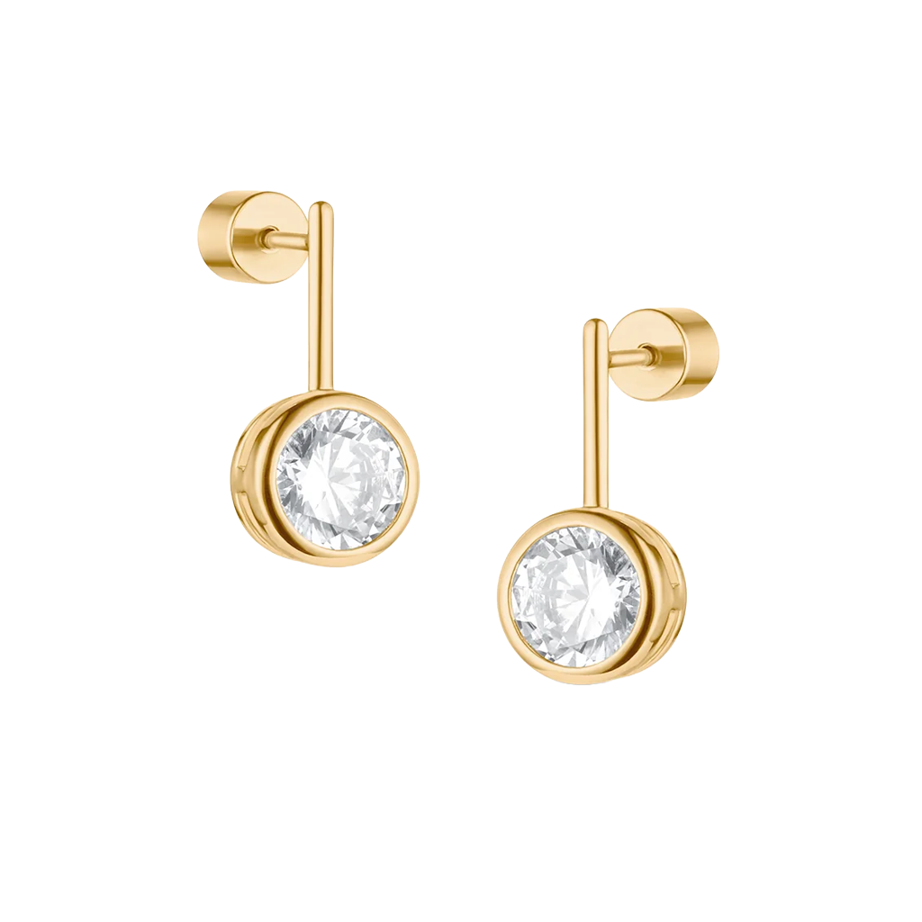 A pair of gold stud earrings with round bezel-set clear gemstones, shown on a plain white background.