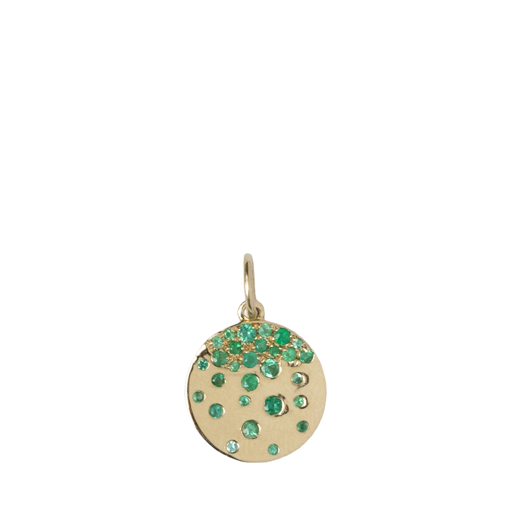 Gold pendant with green gemstones on a white background