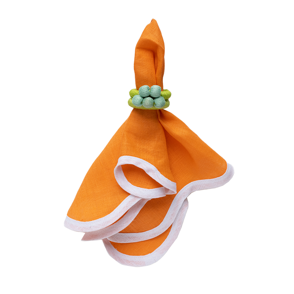 green and aqua napkin ring on orange napkin