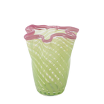 Glass vase with wavy pink rim and green body on a white background