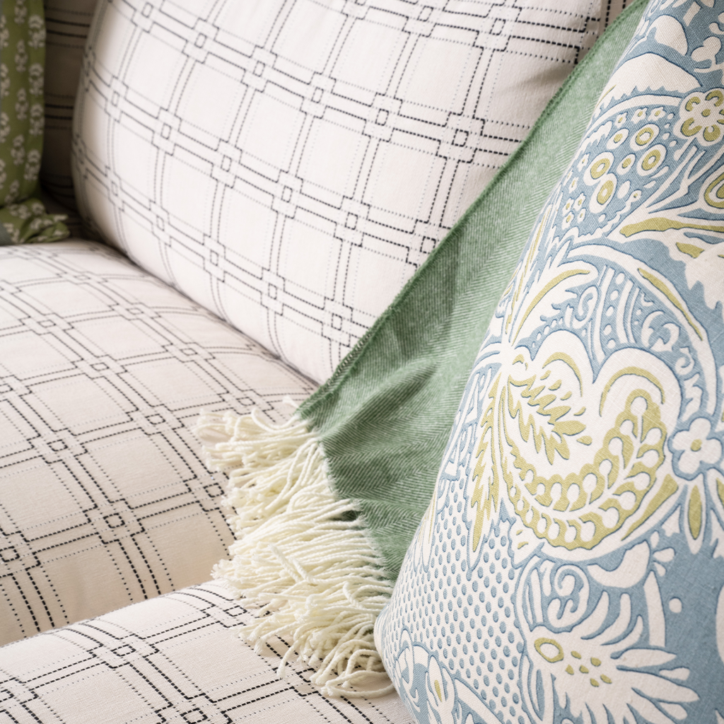 Close-up of patterned cushions on a sofa with a decorative throw.