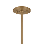 A close-up of a modern ceiling light fixture's round ceiling canopy and downrod in a brushed brass finish, shown against a solid white background.