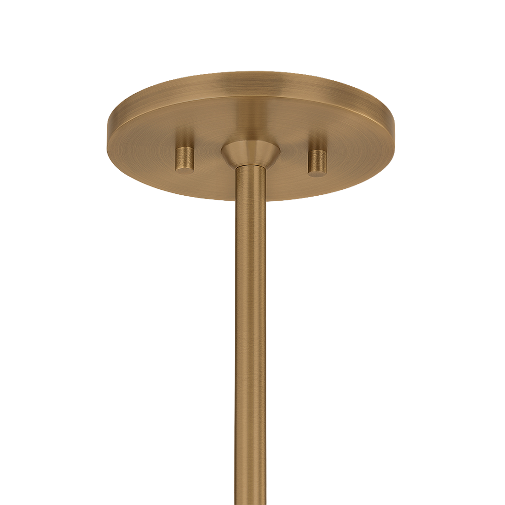 A close-up of a ceiling light fixture's round canopy and downrod in a brushed brass or gold finish, shown against a plain white background.