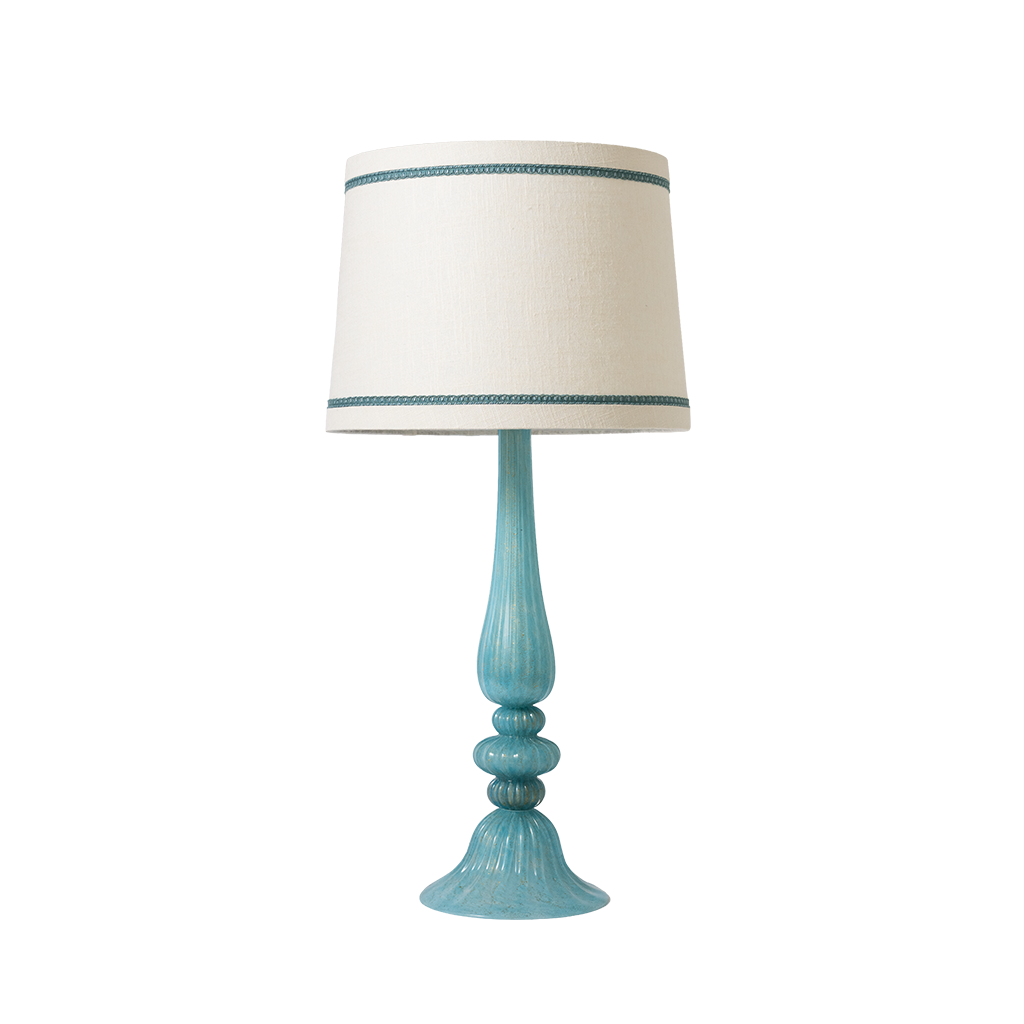 Turquoise table lamp with a white shade on a white background