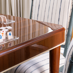 Wooden table with game tiles on a striped chair and rug background