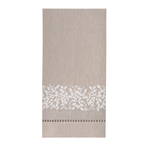 A rectangular beige linen kitchen towel with a white floral lace border and a small geometric pattern near the bottom, shown flat against a white background.