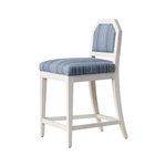 White bar stool with blue patterned cushion on a white background