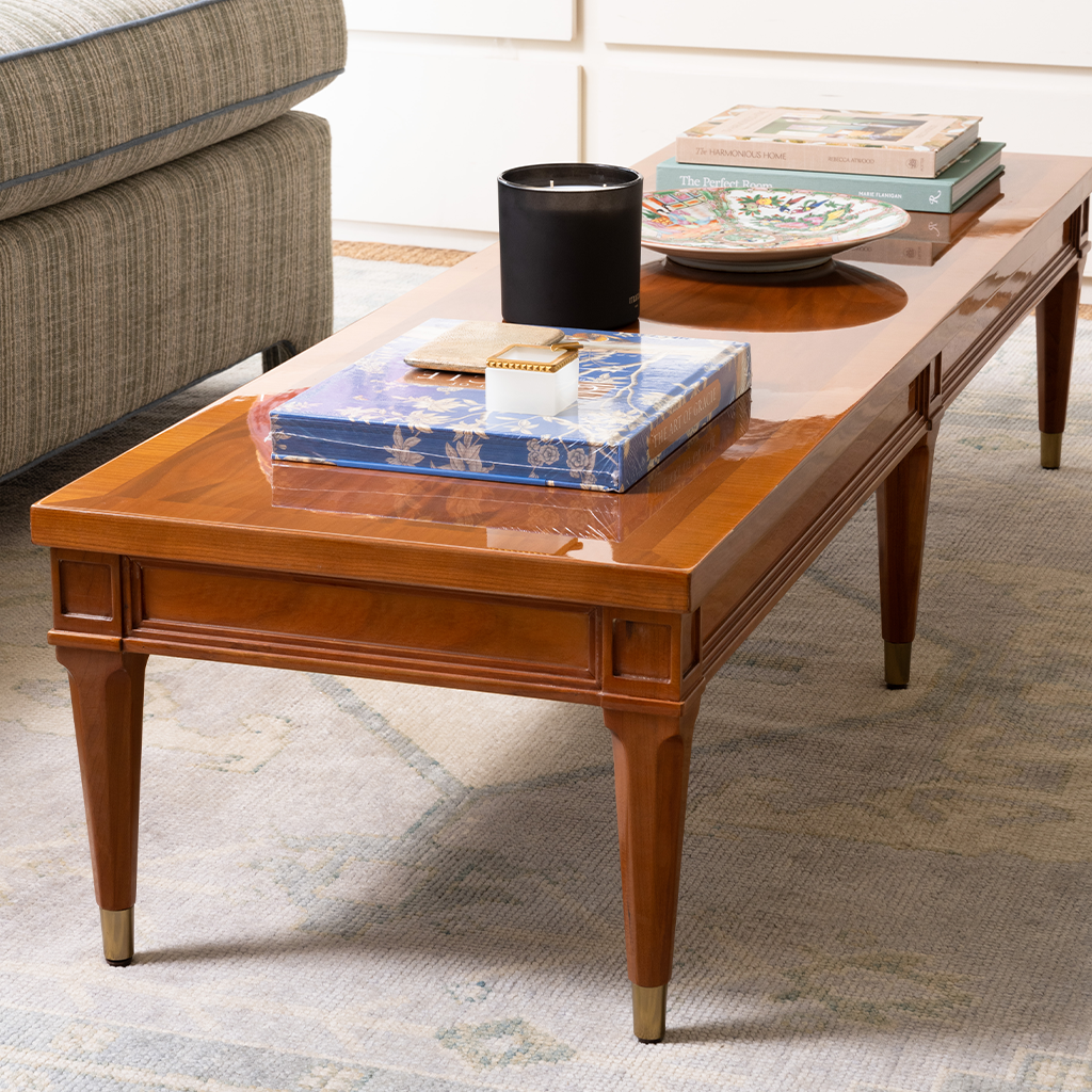 Wooden coffee table with decorative items in a living room setting