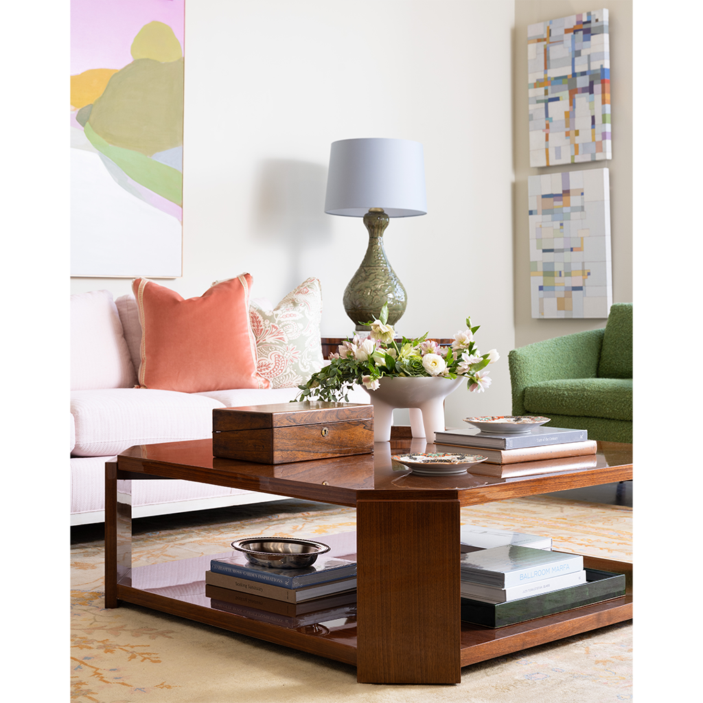 Living room with a wooden coffee table, books, and decorative items.