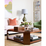 Living room with a wooden coffee table, books, and decorative items.