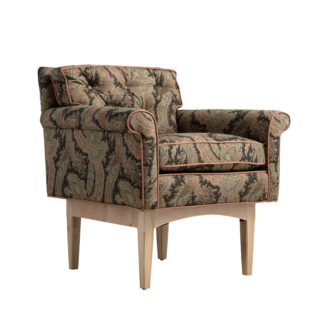 A classic armchair with a detailed paisley patterned fabric in beige, brown, and green, featuring rolled arms, tufted cushions, and light natural wood legs, shown against a plain white background.