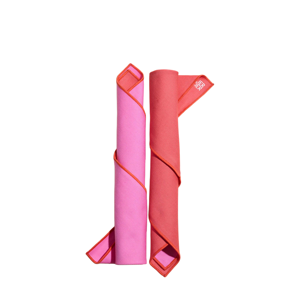 Two rolled-up napkins, one pink and one red, on a white background.