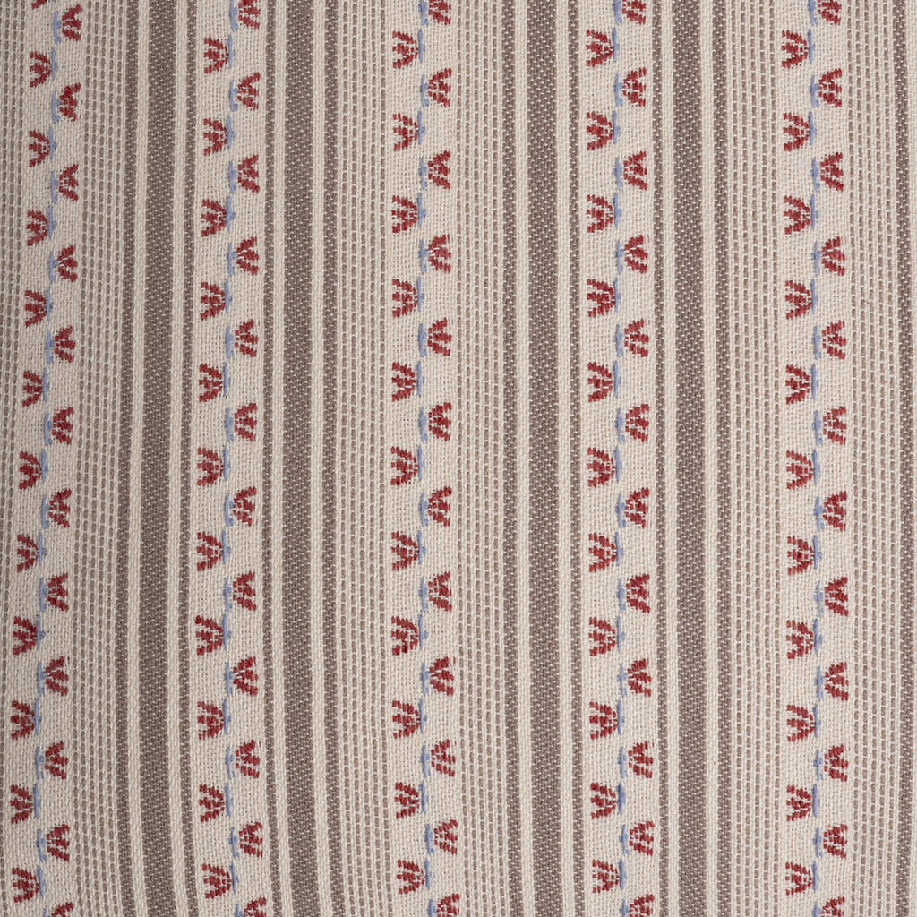 A close-up of a woven textile pattern featuring vertical stripes in taupe and beige, accented with repeating vertical rows of small red and blue stylized motifs.