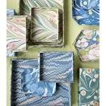 Collection of decorative boxes with marbled patterns on a green background