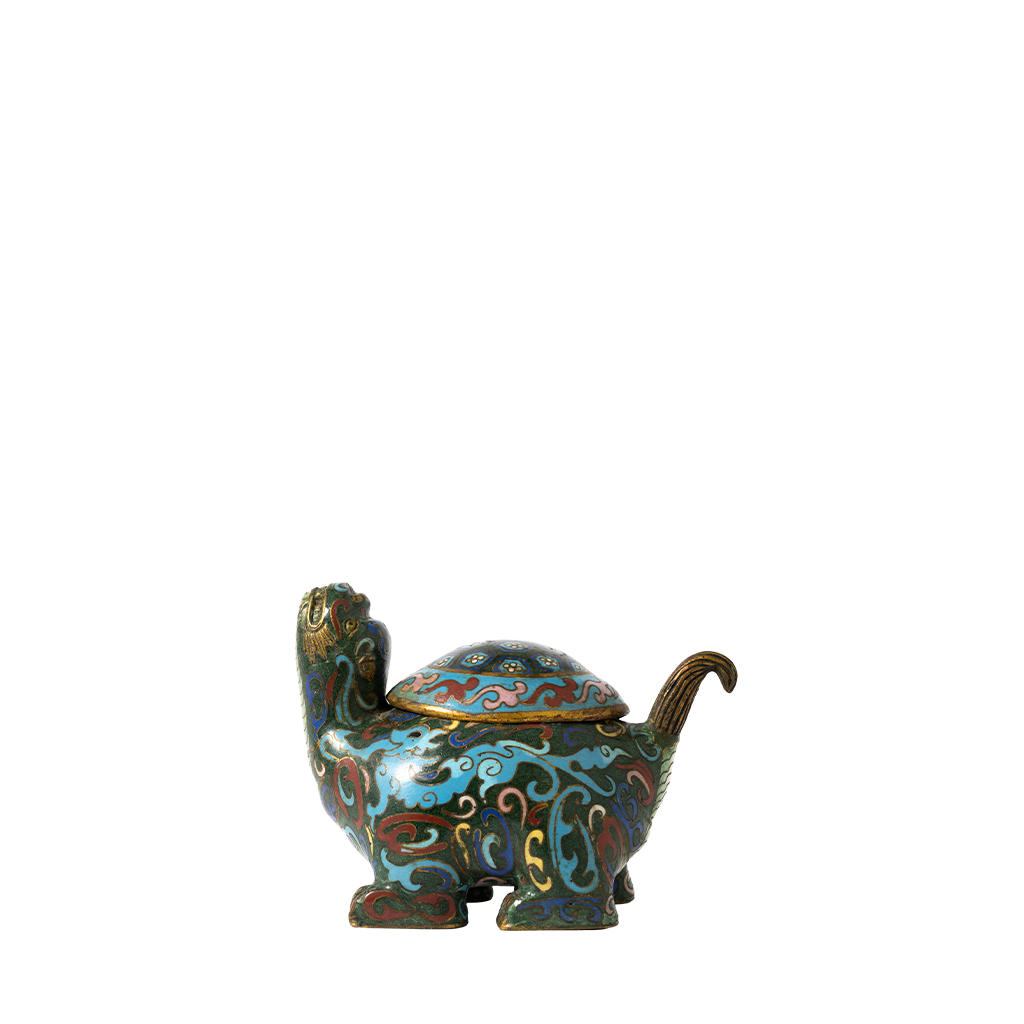 Decorative turtle-shaped container with a lid on a white background