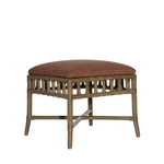 Wicker ottoman with a cushion on a white background