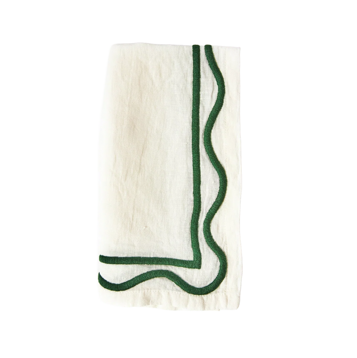 A folded white linen napkin with dark green geometric embroidery on the edges.