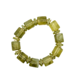 A beaded stretch bracelet made of olive green marbled cylindrical beads separated by small gold spacer rings, shown on a plain white background.