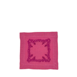 A square pink linen napkin featuring a dark magenta embroidered floral border design in the center, shown flat against a plain white background.
