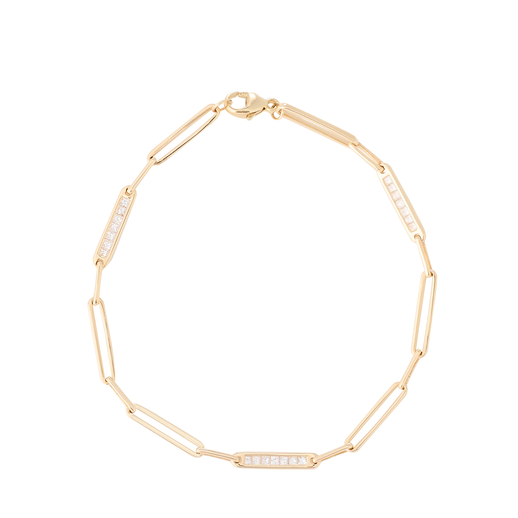 Gold bracelet with embedded stones on a white background