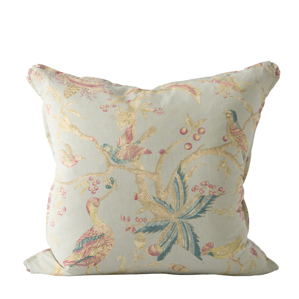 Decorative pillow with bird and floral pattern on a white background