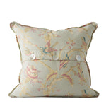 Decorative pillow with floral and bird pattern on a white background